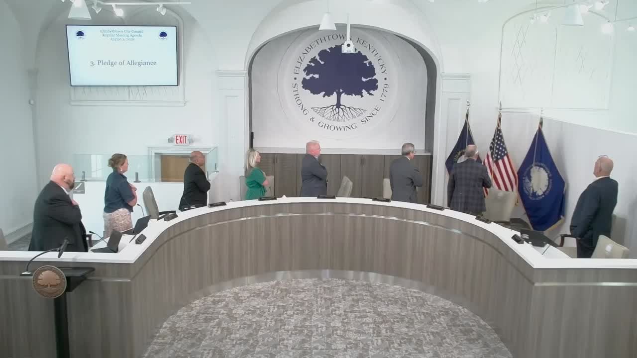 The Elizabethtown City Council standing at the dais during the Pledge of Allegiance at the August 3, 2026 regular meeting