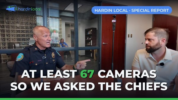 Elizabethtown Police Chief Jeremy Thompson answering questions across a conference table from Hardin Local's Phil Taul