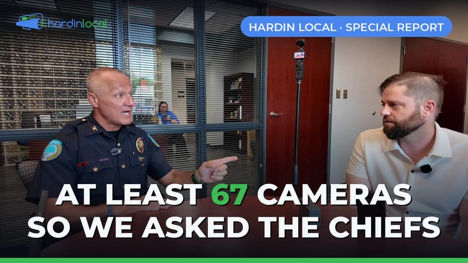 Elizabethtown Police Chief Jeremy Thompson answering questions across a conference table from Hardin Local's Phil Taul